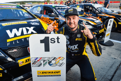 Jack Goff poses behind the 1st place board before heading to the podium